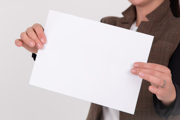 Obraz premium woman showing paper isolated over white background