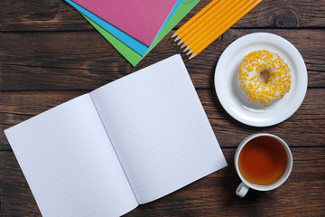 School notebooks, tea and donut