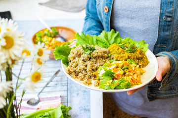 Balanced vegan food. Vegetables with buckwheat grain, lentil, salad.