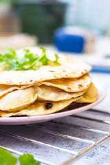 Indian flatbread - chapati with rucola green herbs. Vegan food.