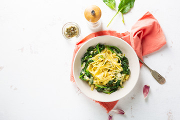Fettuccine pasta with spinach top view, vegan food