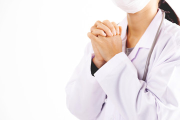 The female doctor in uniform is praying on white background.