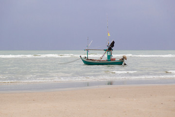 Naklejka premium Boat in the sea in the rainny day