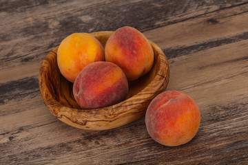 Peach heap in the wooden basket