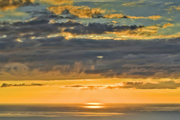 Evening sun and heavy clouds reflect in the water