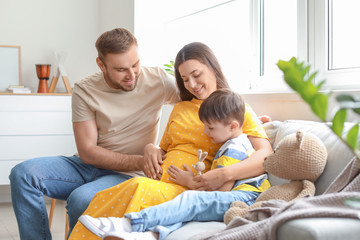 Beautiful pregnant woman with her family at home