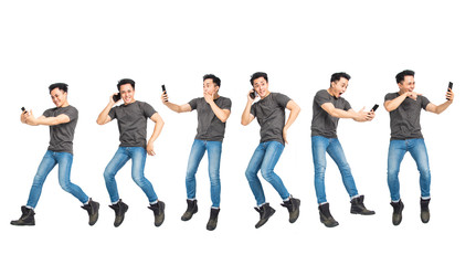 excited young man jumping and using mobile phone concepts