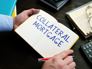 Man writes Collateral Mortgage sign on the sheet.