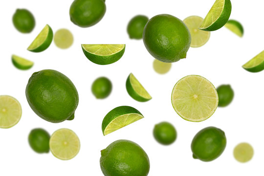 Falling limes isolated on a white background with clipping path as package design element. Flying fruits.