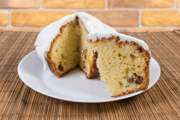 Partly cut cupcake with whipped egg whites icing on dish