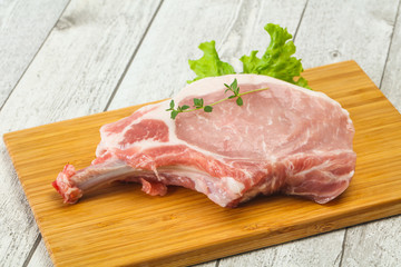 Raw pork bone steak over wooden