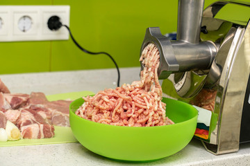 Meat grinder kitchen appliance, closeup with selective focus