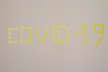 yellow stickers and coronavirus alert on the wall