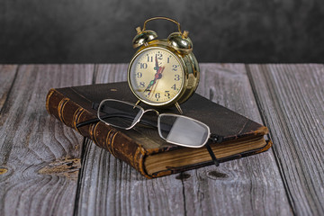A book, reading glasses, and a watch.