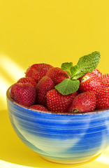 Healthy and fresh strawberries in bowl with mint