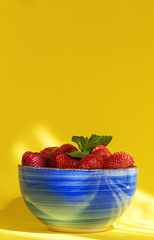 Healthy and fresh strawberries in bowl with mint