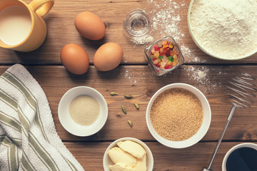 Basic ingredients for cooking Italian Christmas cake panettone on a wooden table