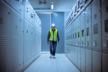 The engineer checking and inspecting at MDB panel.he working with electric switchboard to check range of voltage working in Main Distribution Boards factory.