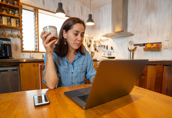 Happy successful young woman on laptop working from home in Coronavirus and New normal concept