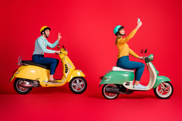 Fototapeta na wymiar Profile side view of her she his he nice attractive cheerful friends friendship riding moped taking selfie showing v-sign having fun isolated on bright vivid shine vibrant red color background