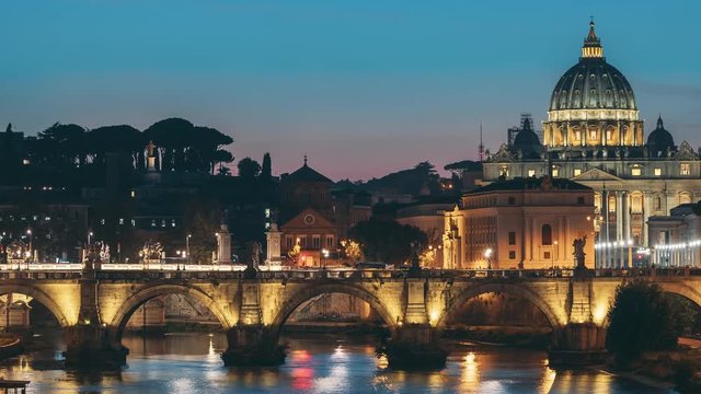 Vatican, Italy. Papal Basilica Of St. Peter In The Vatican And Aelian Bridge In Evening Night Illuminations. Day To NIght Time Lapse. Sunset Time
