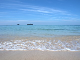 Beautiful sand beach with blue sky cloud , for background and wallpaper, splash water ,sea wave,  koh Chang island Thailand