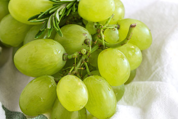 Fresh bunch of grapes on white and blue plate