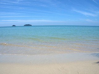 Beautiful sand beach , splash sea water , wave with blue sky cloud , for background and wallpaper ,Koh Chang island Thailand