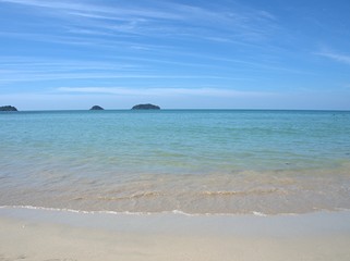Beautiful sand beach with blue sky cloud , for background and wallpaper, splash water ,sea wave, koh Chang island Thailand	