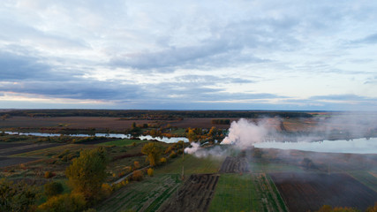 smoke in the field. aerial view