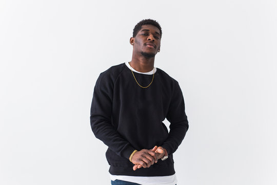 Street fashion concept - Studio shot of young handsome African man wearing sweatshirt against white background.