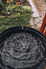 Fototapeta premium Rain Water Is Streaming Into Barrel In The Garden