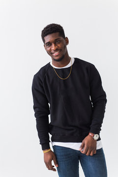 Handsome African American man posing in black sweatshirt on a white background. Youth street fashion photo with afro hairstyle.
