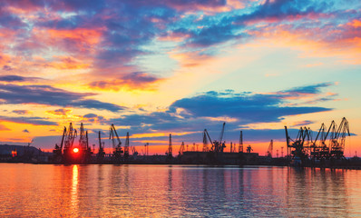 Fototapeta na wymiar Sea port and industrial cranes, Varna, Bulgaria.Sunset over the Varna lake