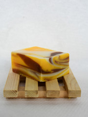 ecological soap on a wooden soap dish yellow handmade soap