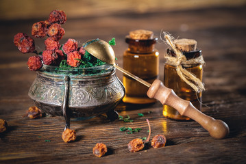 Bottle of magic potion on the witch doctor table close up.