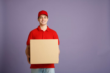 Fast delivery and big parcel. Caucasian post worker gives out big box