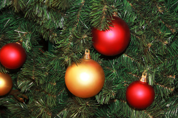 decorative toys balls on a green Christmas tree for the new year holiday