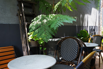 Outdoor patio terrace decorated with wooden green plant pot, chair and table set