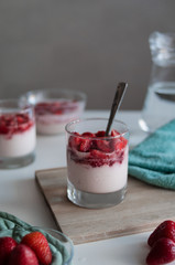 Delicious Italian dessert panna cotta or strawberry mousse on white table in the morning. 