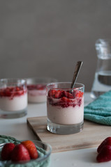 Delicious Italian dessert panna cotta or strawberry mousse on white table in the morning. 