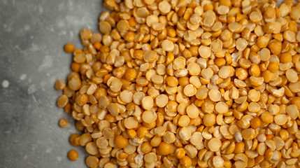 dry peas on a light wooden background.
