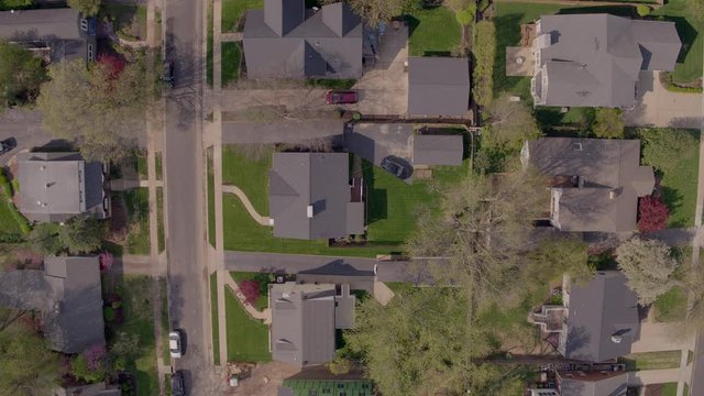 Wide Overhead View Of Houses In Suburban Neighborhood With Descend Down To House.