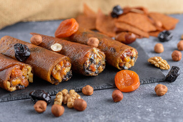 rolls with dried fruits, Eastern sweets on gray background