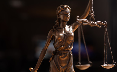 Statue of lady justice on bright background - Side view with copy space..