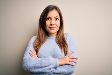 Beautiful young woman wearing casual winter sweater standing over isolated background happy face smiling with crossed arms looking at the camera. Positive person.