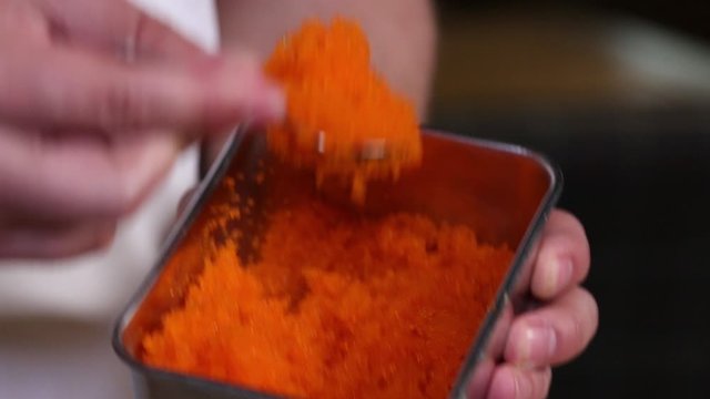 the chef mixes the caviar.