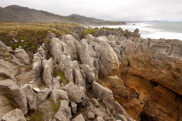 The stunning rocks of Punakaiki, Pancake rocks blowholes, are a tourist attraction. South Island of New Zealand