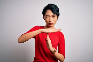 Young beautiful asian girl wearing casual red t-shirt standing over isolated white background Doing...