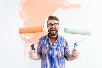 Funny guy painting wall. Renovation, redecoration and repair concept.